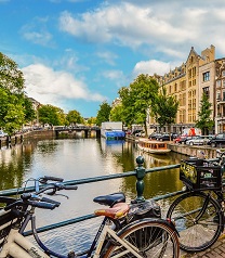 A photograph of bikes parked alongside a canal in the Netherlands